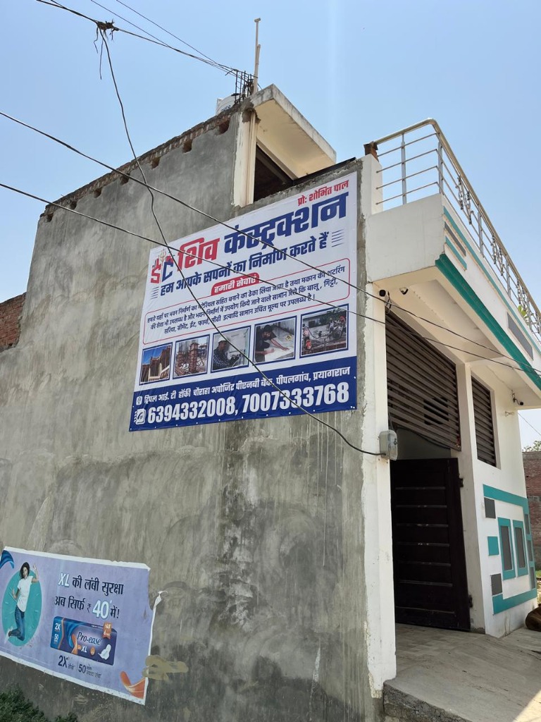 Hindi flex banner of Shiv Construction on active construction building site